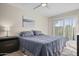 Inviting bedroom with sliding glass doors, ceiling fan, and neutral color scheme at 735 E Cochise Dr, Phoenix, AZ 85020