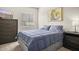 Cozy bedroom features a comfortable bed, dark dresser, and a bright window for natural light at 735 E Cochise Dr, Phoenix, AZ 85020