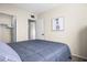 Comfortable bedroom with a bed, closet, and colorful art at 735 E Cochise Dr, Phoenix, AZ 85020