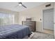 Pleasant bedroom featuring a bed, dresser with a TV, and a ceiling fan at 735 E Cochise Dr, Phoenix, AZ 85020