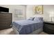 Cozy bedroom features a comfortable bed, dark dresser, and a bright window for natural light at 735 E Cochise Dr, Phoenix, AZ 85020