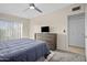 Cozy bedroom featuring a bed, dresser with a TV, and a ceiling fan at 735 E Cochise Dr, Phoenix, AZ 85020