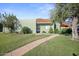 Attractive single-story home featuring a well-maintained lawn and mature trees at 735 E Cochise Dr, Phoenix, AZ 85020