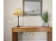 Hallway features a wooden console table, a framed mirror, and a decorative potted plant at 735 E Cochise Dr, Phoenix, AZ 85020