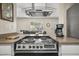 Modern kitchen showcasing a stove with sleek countertops, with an open floor plan into a cozy living area at 735 E Cochise Dr, Phoenix, AZ 85020