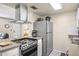 Bright kitchen featuring stainless steel appliances, a stove top, and neutral countertops at 735 E Cochise Dr, Phoenix, AZ 85020