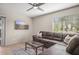 Spacious living room featuring a comfortable sofa and desert-scape television display at 735 E Cochise Dr, Phoenix, AZ 85020
