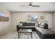 Welcoming living room with neutral colors, modern TV, comfortable gray sectional and a view to the outside at 735 E Cochise Dr, Phoenix, AZ 85020