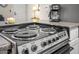 Close up of electric range; a candle and coffee maker sit on the countertop in the background at 735 E Cochise Dr, Phoenix, AZ 85020