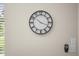 Close up of a round wall clock with black frame and white face on a beige wall at 735 E Cochise Dr, Phoenix, AZ 85020