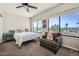 Bright bedroom with scenic views, ceiling fan, and comfortable seating at 7400 E Gainey Club Dr # 206, Scottsdale, AZ 85258