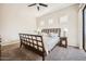 Spacious bedroom with a fan, shutters, a queen bed and balcony access at 7400 E Gainey Club Dr # 206, Scottsdale, AZ 85258