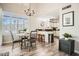 Open concept dining area with eat-in kitchen, modern lighting, and ample windows at 7400 E Gainey Club Dr # 206, Scottsdale, AZ 85258