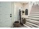 Warm entryway featuring stylish decor, a coat rack, and a staircase at 7400 E Gainey Club Dr # 206, Scottsdale, AZ 85258