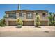 Contemporary townhome featuring three garage doors and well-maintained landscaping at 7400 E Gainey Club Dr # 206, Scottsdale, AZ 85258