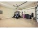 Organized two car garage with epoxy floor, lighting, and storage at 7400 E Gainey Club Dr # 206, Scottsdale, AZ 85258