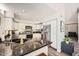 Well-lit kitchen features granite counters, stainless steel appliances, and wood flooring at 7400 E Gainey Club Dr # 206, Scottsdale, AZ 85258