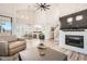 Bright open concept living room with fireplace, eat-in kitchen, modern fixtures, and vaulted ceilings at 7400 E Gainey Club Dr # 206, Scottsdale, AZ 85258