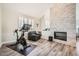 Inviting living room with stone fireplace, wood floors, and natural light at 7400 E Gainey Club Dr # 206, Scottsdale, AZ 85258