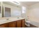 Well-lit bathroom includes a double sink vanity, large mirror, and shower-tub combo at 9534 N 82Nd Ln, Peoria, AZ 85345