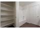Bathroom showcasing a shower-tub combo and shelving for storage at 9534 N 82Nd Ln, Peoria, AZ 85345