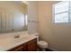 Bathroom features a wood vanity, laminate countertop, single sink, and a large mirror at 9534 N 82Nd Ln, Peoria, AZ 85345
