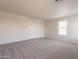Bright bedroom featuring neutral carpet, a window for natural light, and a built-in closet at 9534 N 82Nd Ln, Peoria, AZ 85345