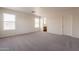 Large bedroom featuring neutral carpet, white walls, and bright windows at 9534 N 82Nd Ln, Peoria, AZ 85345