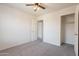 Bedroom with carpet, a ceiling fan, a closet, and a window at 9534 N 82Nd Ln, Peoria, AZ 85345