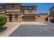 Inviting two-story townhome with a two-car garage and a well-maintained, desert-landscaped front yard at 9534 N 82Nd Ln, Peoria, AZ 85345