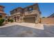 Inviting two-story townhome with a two-car garage and a well-maintained, desert-landscaped front yard at 9534 N 82Nd Ln, Peoria, AZ 85345