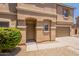 Welcoming front entrance of a townhome featuring desert landscaping and a covered entryway at 9534 N 82Nd Ln, Peoria, AZ 85345