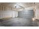 Spacious garage featuring a two-car door and ample room for storage at 9534 N 82Nd Ln, Peoria, AZ 85345