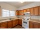 Functional kitchen featuring wood cabinets, laminate countertops, and essential appliances at 9534 N 82Nd Ln, Peoria, AZ 85345