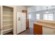Kitchen with wood cabinets, laminate countertops, white refrigerator, and a view into the carpeted living area at 9534 N 82Nd Ln, Peoria, AZ 85345
