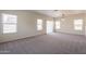 Spacious carpeted living room with bright, natural light and a neutral color scheme at 9534 N 82Nd Ln, Peoria, AZ 85345