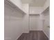 Walk-in closet featuring built-in shelving and carpet flooring at 9534 N 82Nd Ln, Peoria, AZ 85345