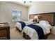 Bright bedroom featuring two twin beds, neutral walls, a window with shutters and carpeted floor at 9802 E Hidden Valley Rd, Scottsdale, AZ 85262