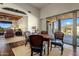 Cozy dining area with wooden table and chairs with natural light and scenic views at 9802 E Hidden Valley Rd, Scottsdale, AZ 85262
