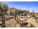 Home exterior with a fire pit and desert landscaping including cacti and other native plants at 9802 E Hidden Valley Rd, Scottsdale, AZ 85262
