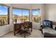 Bright home office with a built-in desk, comfortable seating, and scenic views at 9802 E Hidden Valley Rd, Scottsdale, AZ 85262
