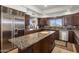 Modern kitchen featuring granite countertops, stainless steel appliances, and ample cabinet space at 9802 E Hidden Valley Rd, Scottsdale, AZ 85262