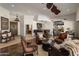 Spacious living room featuring dark wood floors, leather seating and access to a bar area at 9802 E Hidden Valley Rd, Scottsdale, AZ 85262