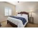 Inviting main bedroom with an ornate headboard, comfy bedding, and shuttered windows allowing ample light at 9802 E Hidden Valley Rd, Scottsdale, AZ 85262
