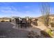 Outdoor kitchen and bar area with seating and views of the surrounding desert landscape at 9802 E Hidden Valley Rd, Scottsdale, AZ 85262