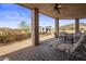 Inviting outdoor patio with brick pavers, a ceiling fan, and scenic views of desert landscape at 9802 E Hidden Valley Rd, Scottsdale, AZ 85262