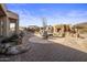 Inviting outdoor living space features a stone fireplace, built-in seating, and desert landscaping at 9802 E Hidden Valley Rd, Scottsdale, AZ 85262