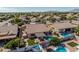 A backyard boasts an in-ground pool, covered patio, and pristine artificial grass at 10413 E Emelita Ave, Mesa, AZ 85208