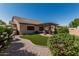 Well-manicured backyard features a pergola covered seating area, lush lawn, and mature landscaping at 10413 E Emelita Ave, Mesa, AZ 85208