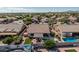 This backyard has a refreshing in-ground pool, covered patio, and manicured artificial grass at 10413 E Emelita Ave, Mesa, AZ 85208